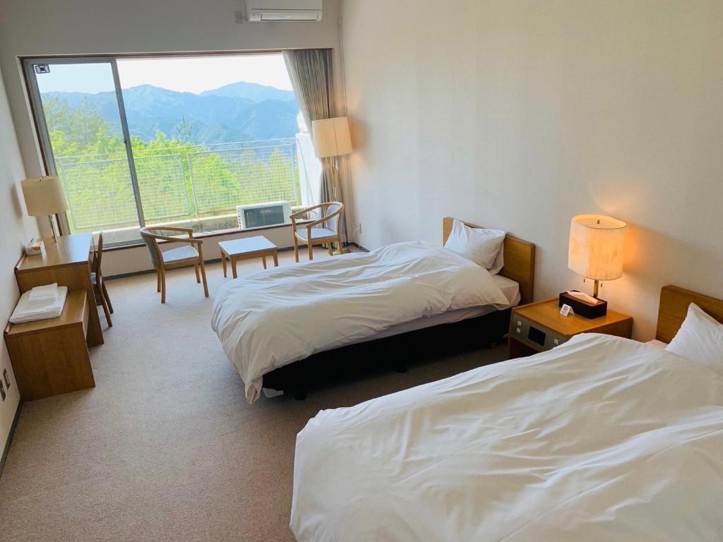 a hotel room with two beds and a window at Starry Sky and Sea of Clouds Hotel Terrace Resort - Vacation STAY 75220v in Takeda