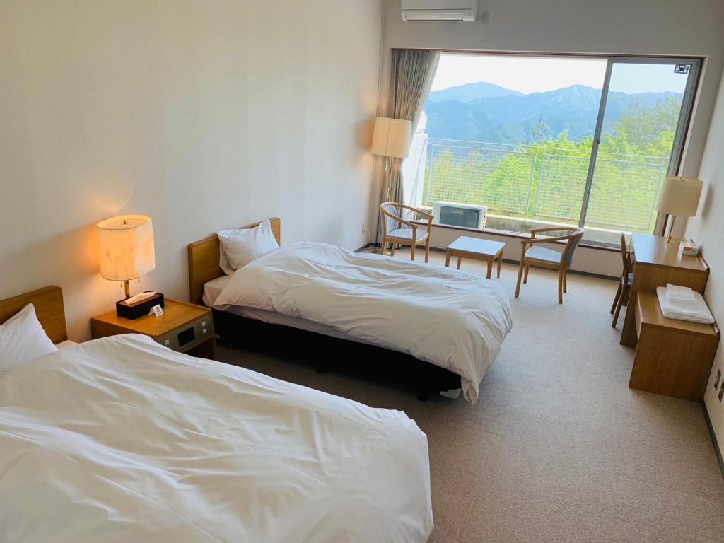 a hotel room with two beds and a window at Starry Sky and Sea of Clouds Hotel Terrace Resort - Vacation STAY 75205v in Takeda