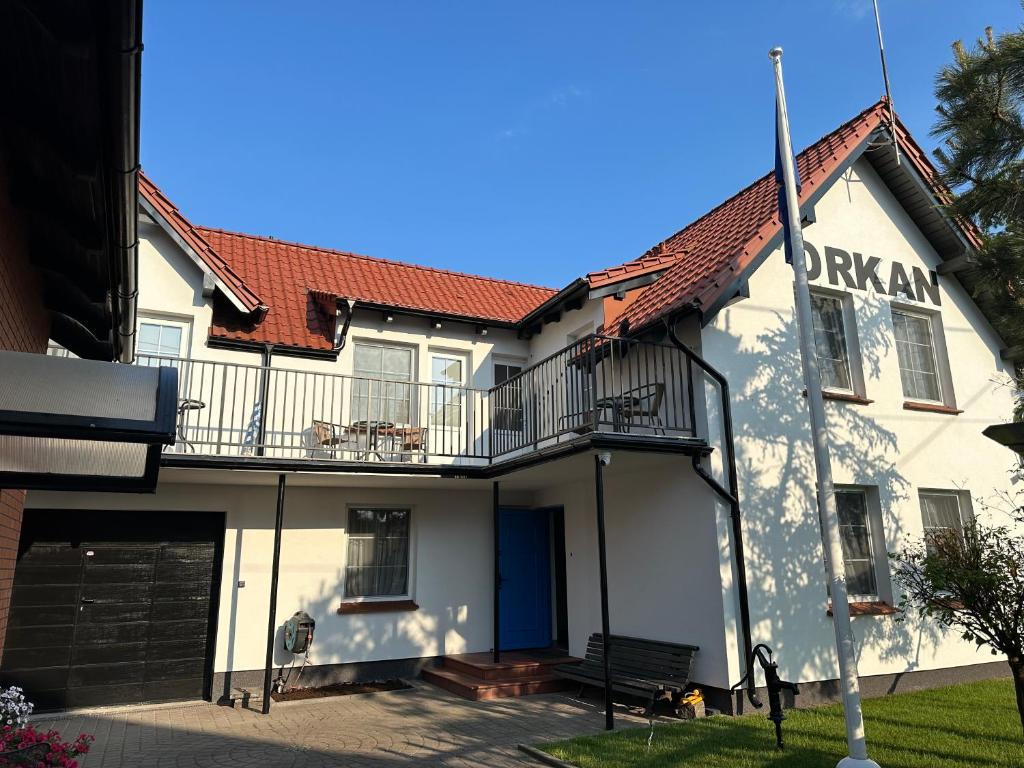 a white building with a red roof at Orkan in Kuźnica