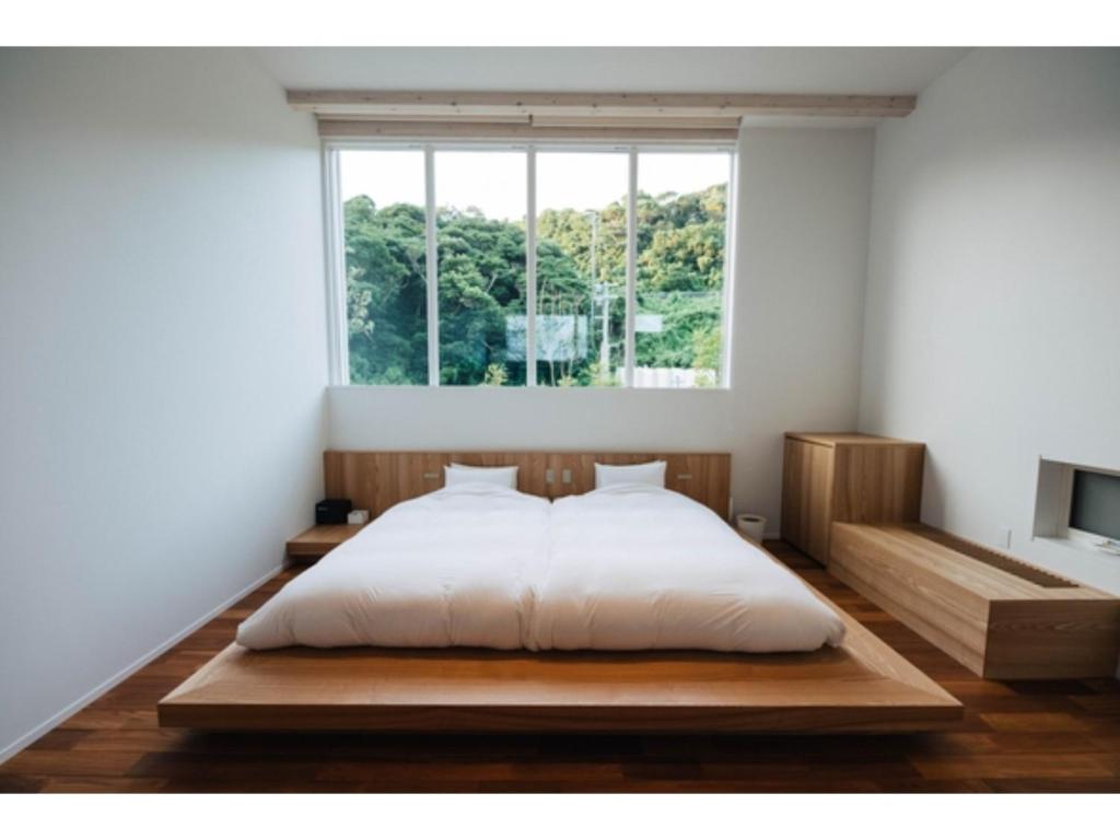 a bedroom with a bed and a large window at Colorit Goto Islands - Vacation STAY 61533v in Goto
