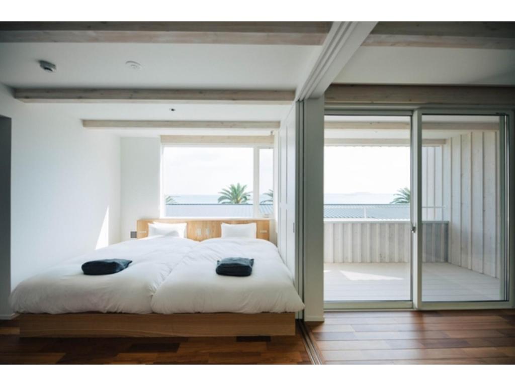 a bedroom with a large bed and a balcony at Colorit Goto Islands - Vacation STAY 61530v in Goto