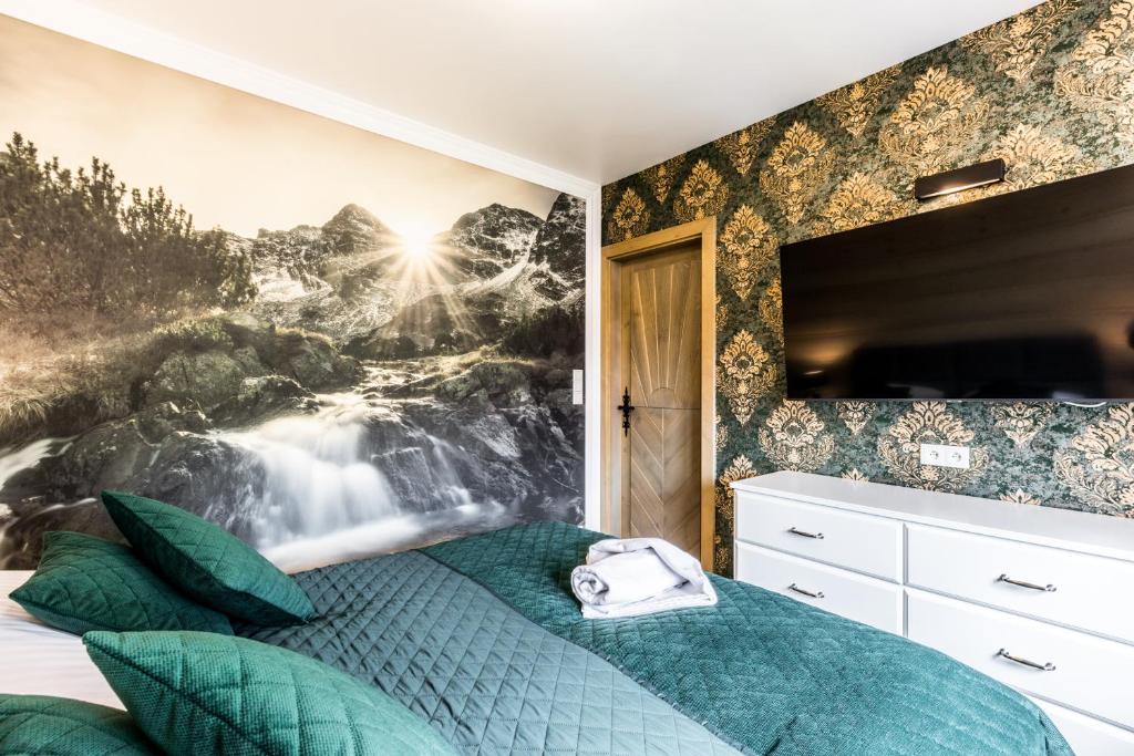 a bedroom with a waterfall mural on the wall at Apartamenty Tradycja in Zakopane