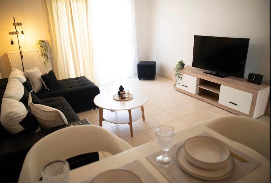 a living room with a couch and a tv at Diana’s Place in Alexandroupoli
