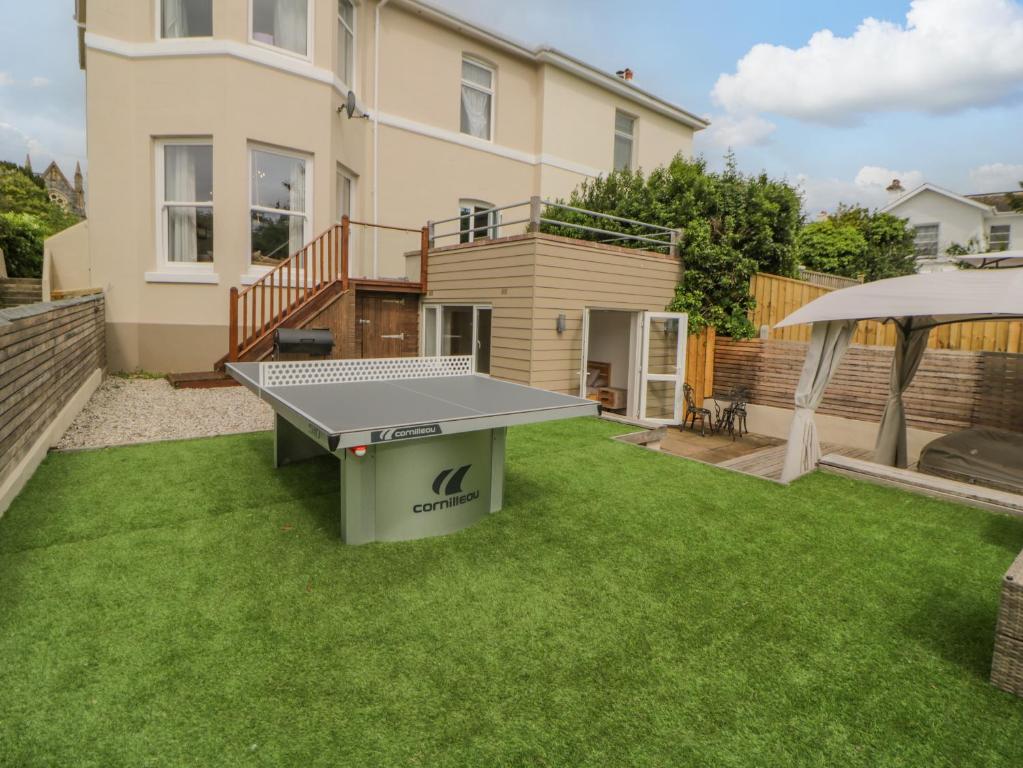 a ping pong table in the yard of a house at The Priory in Torquay