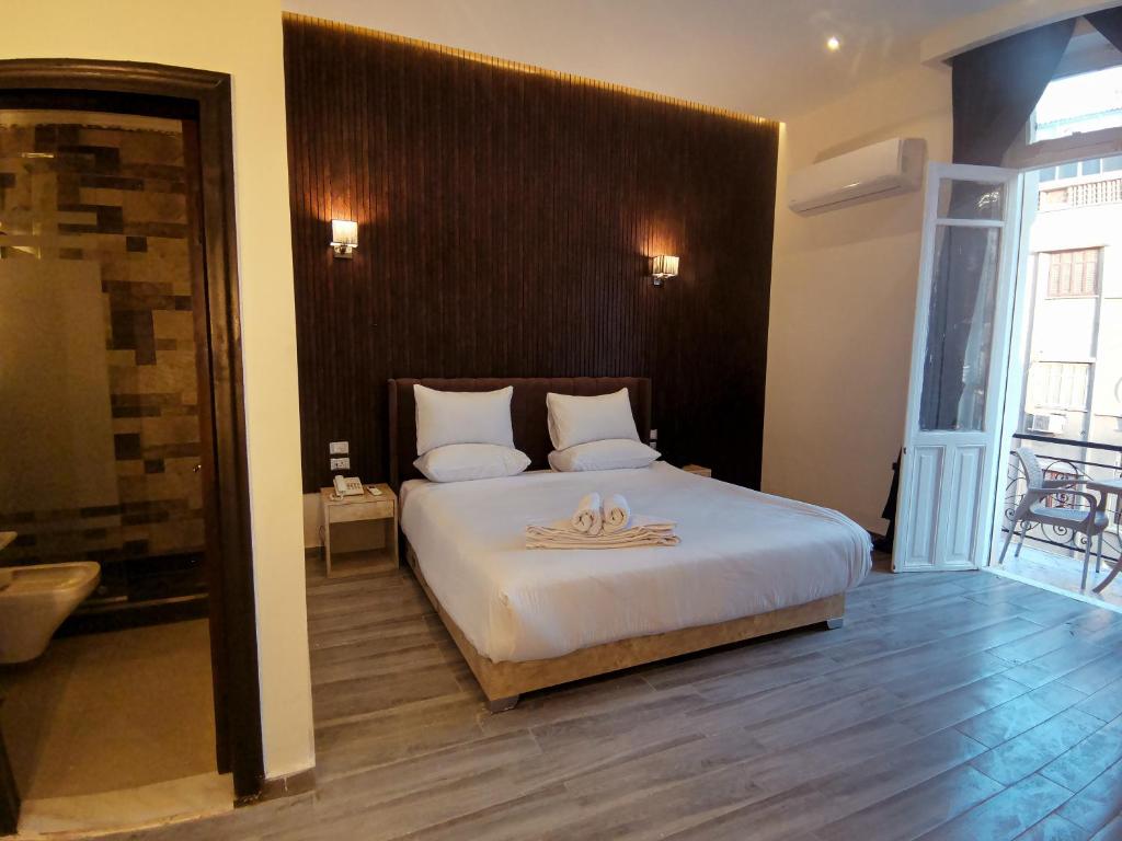 Postel nebo postele na pokoji v ubytování Tourist Palace Hotel