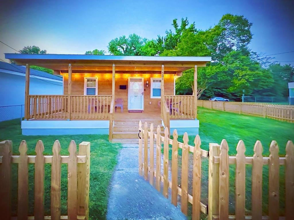 a house with a wooden fence in front of it at Cottage in Heart of Colonial Beach, 7 Mins Walk to the Beach in Colonial Beach