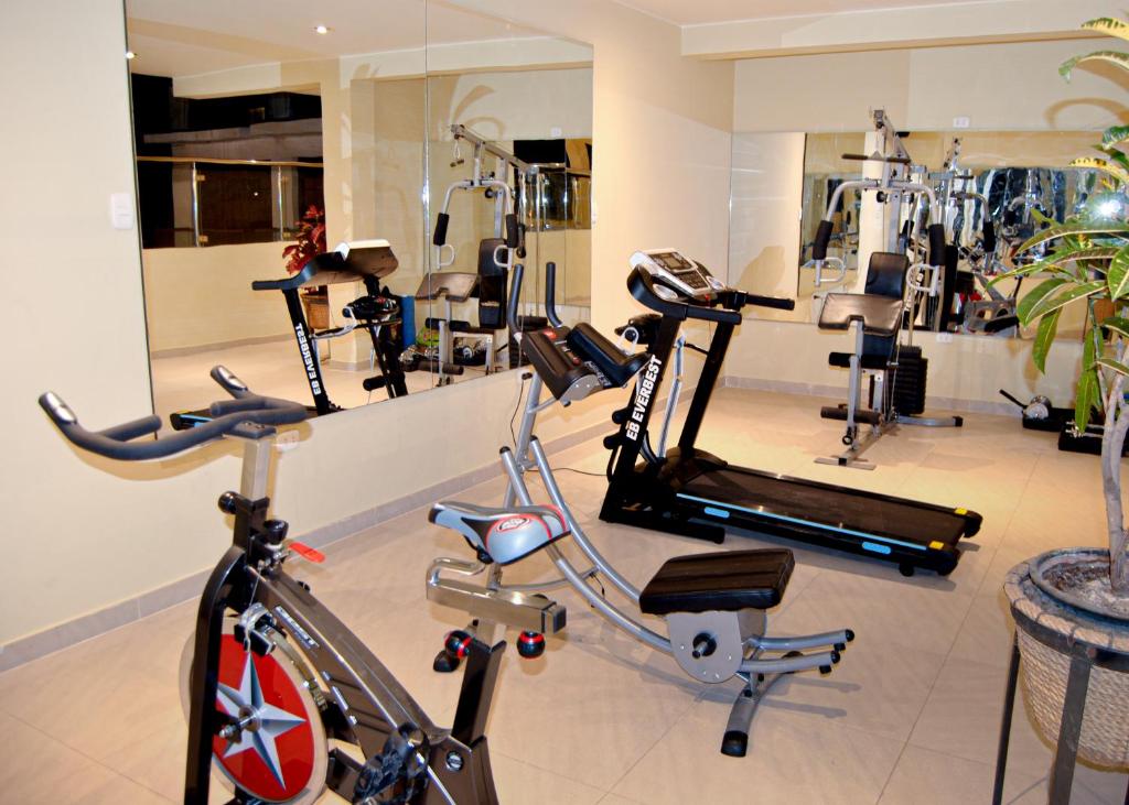 a gym with a bike and several tread machines at Mc Hotel Ica in Ica