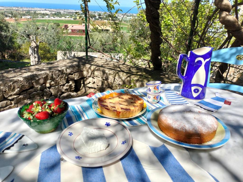a table with plates of food and fruit on it at le finestre sul mare in Conversano