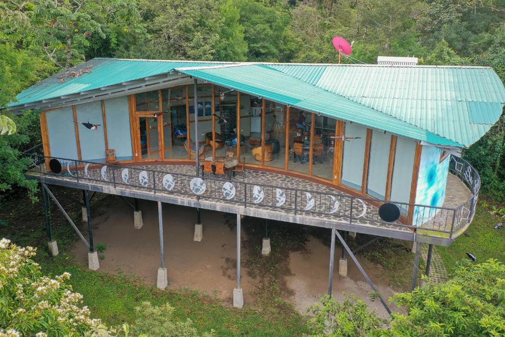 una casa con techo azul en el agua en Moon Wonders Vacation House, en Monteverde