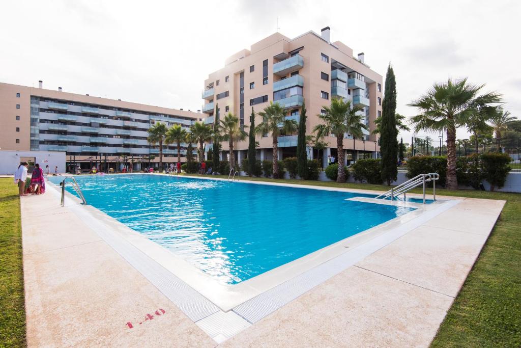 a large swimming pool in front of a building at UNIVERSITY & TECH PARK MALAGA APARTMENT in Málaga
