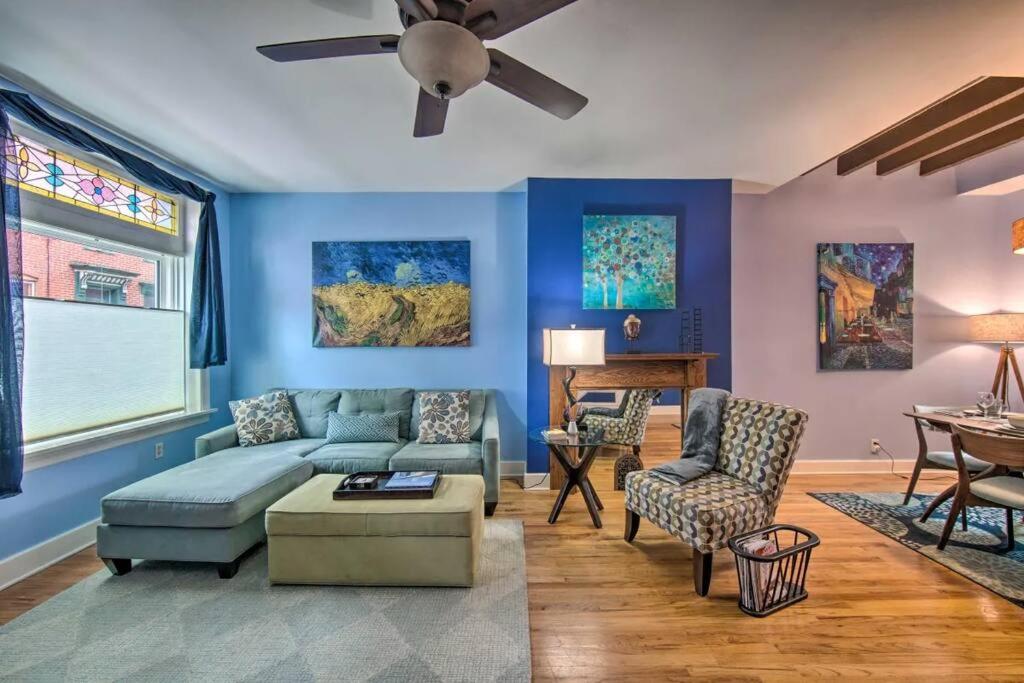 a living room with blue walls and a ceiling fan at Contemporary Townhome in Midtown Harrisburg! in Harrisburg