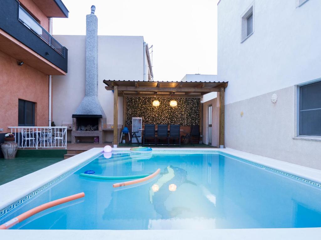 a swimming pool in a house with a fireplace at MM DELTA HOLIDAYS in El Lligallo del Gànguil