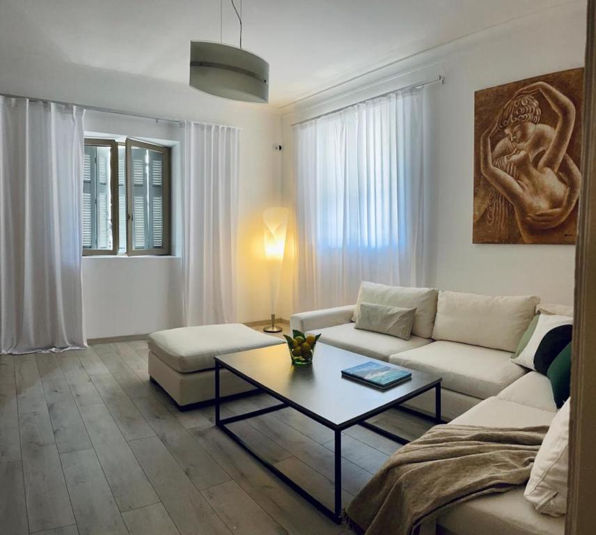 a living room with a couch and a coffee table at The Acropolis Cave Apartment in Athens