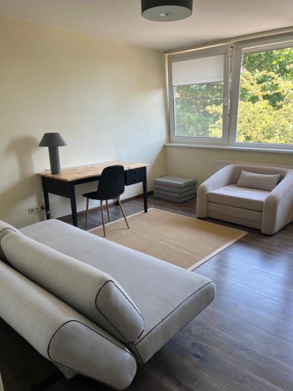 a living room with a couch and a desk at Une-max in Nida