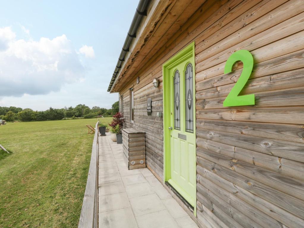 a house with a green door on the side of it at Lulu Logs in Bristol