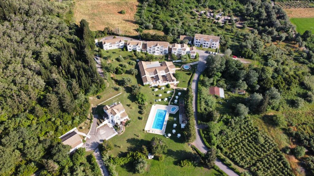 an aerial view of a house with a swimming pool at Rebecca's Village Corfu Hotel in Karousádes