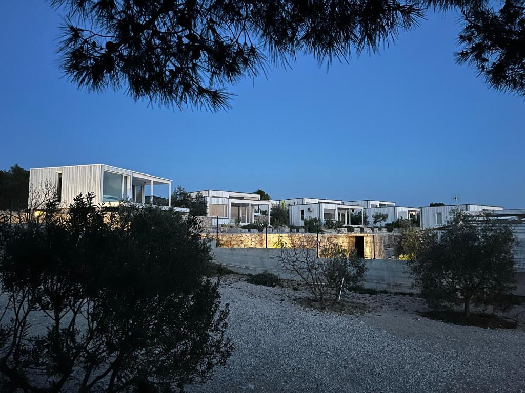 a view of a building with buildings in the background at BUQEZ ECO RESORT - Beach Villas 2 and 8 - Seaview, new wifi! in Drage