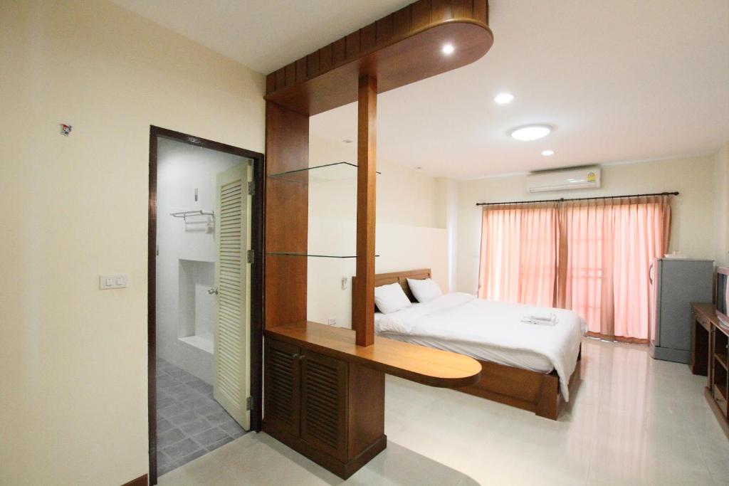 a bedroom with a bed and a walk in shower at Noppakao Place in Chiang Mai