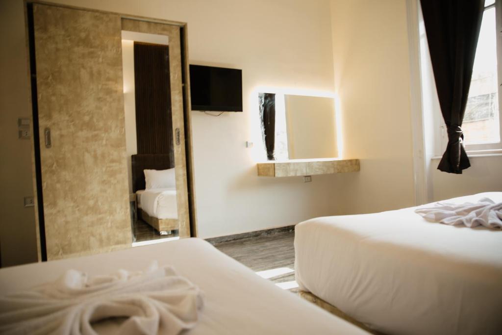 Postel nebo postele na pokoji v ubytování Tourist Palace Hotel