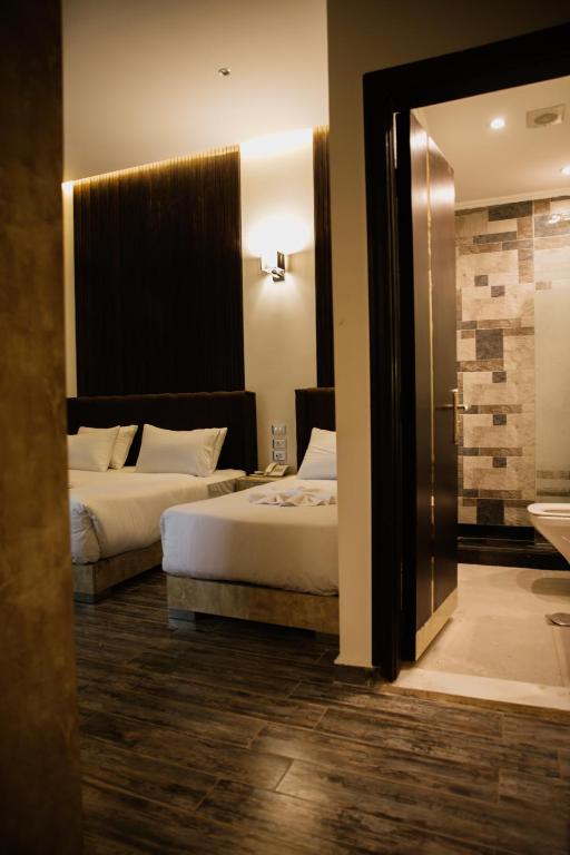 Postel nebo postele na pokoji v ubytování Tourist Palace Hotel