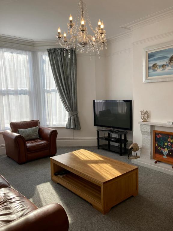 uma sala de estar com um sofá e uma mesa de centro em Seaferns em Weston-super-Mare