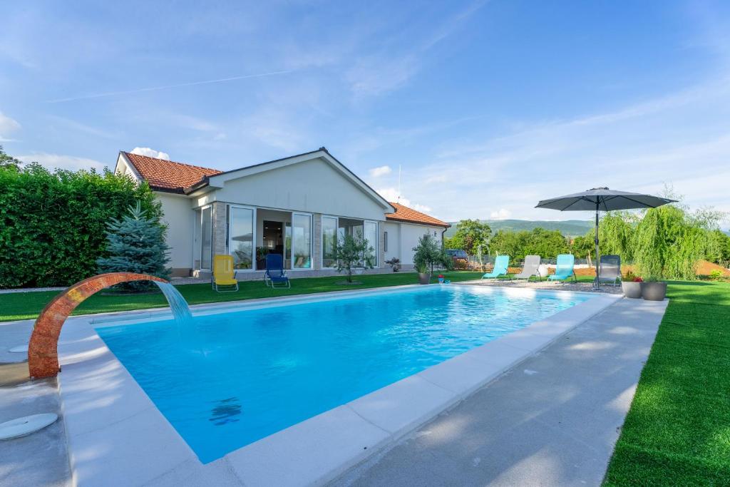 a swimming pool in the backyard of a house at Holiday home Carpinus in Široki Brijeg