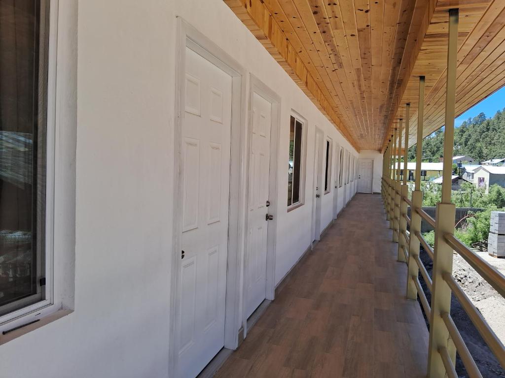 a hallway with white doors and a wooden ceiling at Villas la Quinta (etapa Aserradero) in Creel