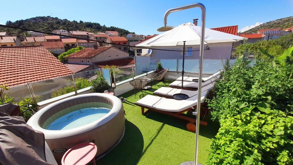 a hot tub on the roof of a house at Apartments Stella Mariela in Šibenik
