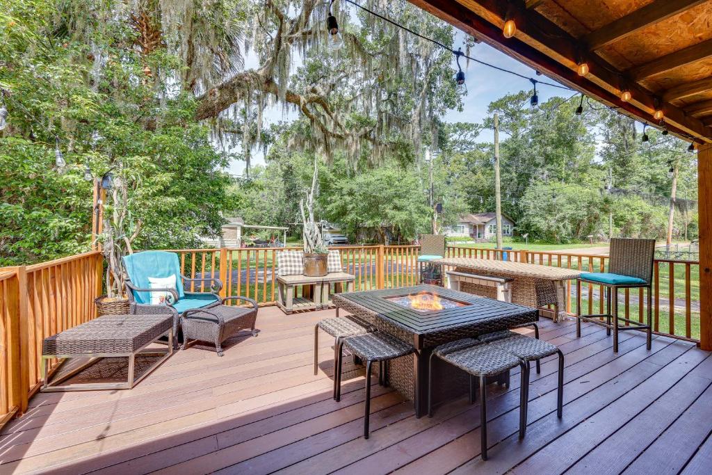 a deck with a table and chairs and a fire pit at Jacksonville Vacation Rental with Deck! in Jacksonville