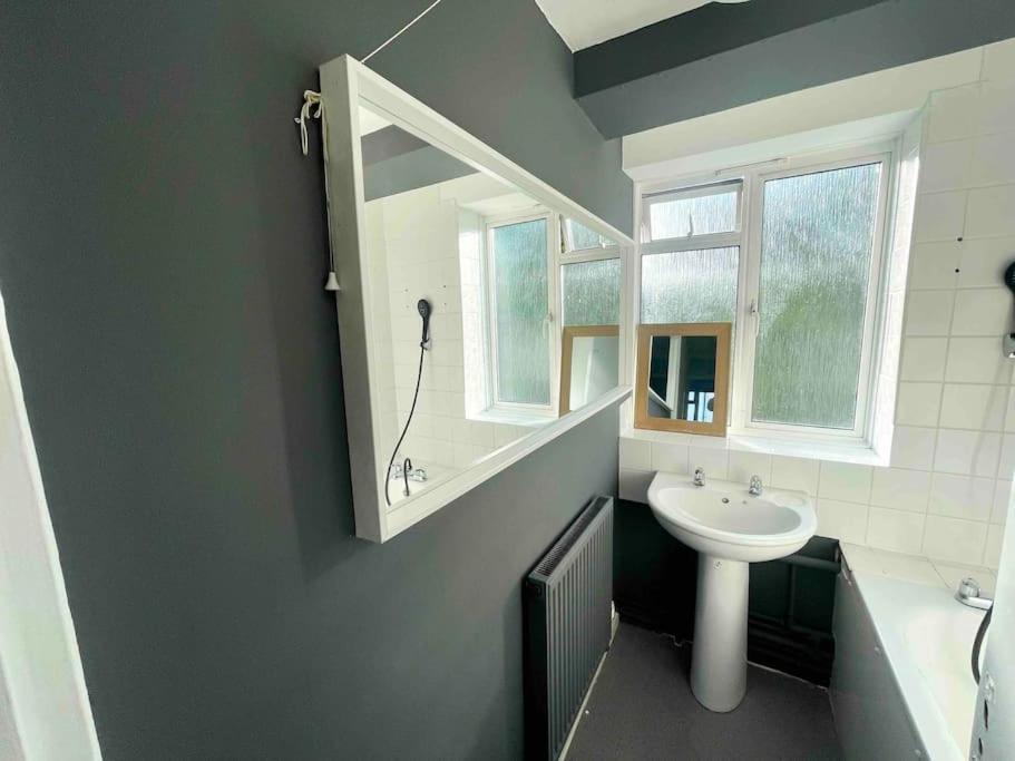a bathroom with a white sink and a mirror at Stylish 2 bedroom flat in Angel Central Location in London