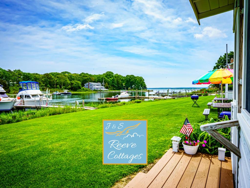 a sign on the porch of a home with a view of the water at Premier Waterfront Cottage 2 in Riverhead