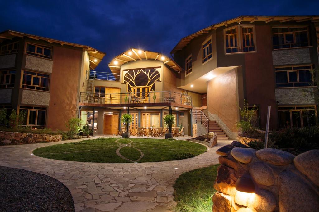 a large house with a patio and a yard at Fleur Lodge in Carhuaz