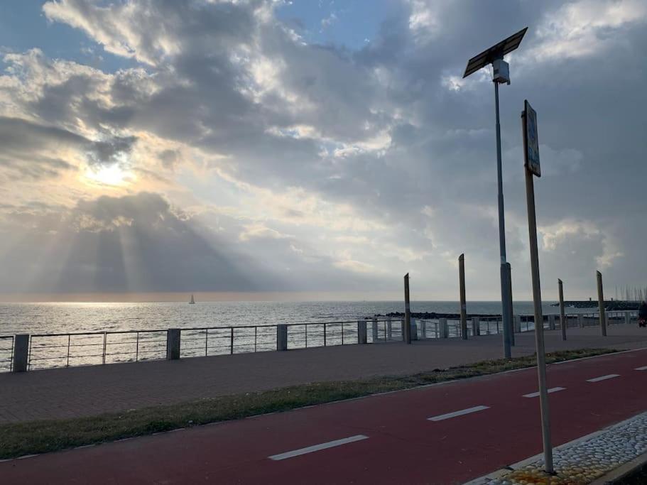 a street light on the side of a road near the ocean at Rome's Harbour all year in Lido di Ostia