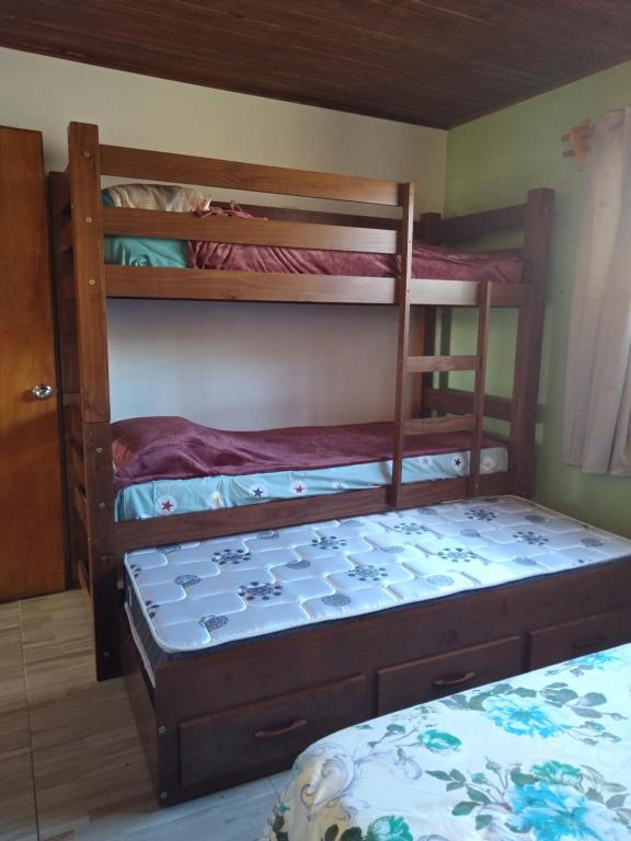 a bedroom with two bunk beds and a bed at hospedaje vicenzo in Melo