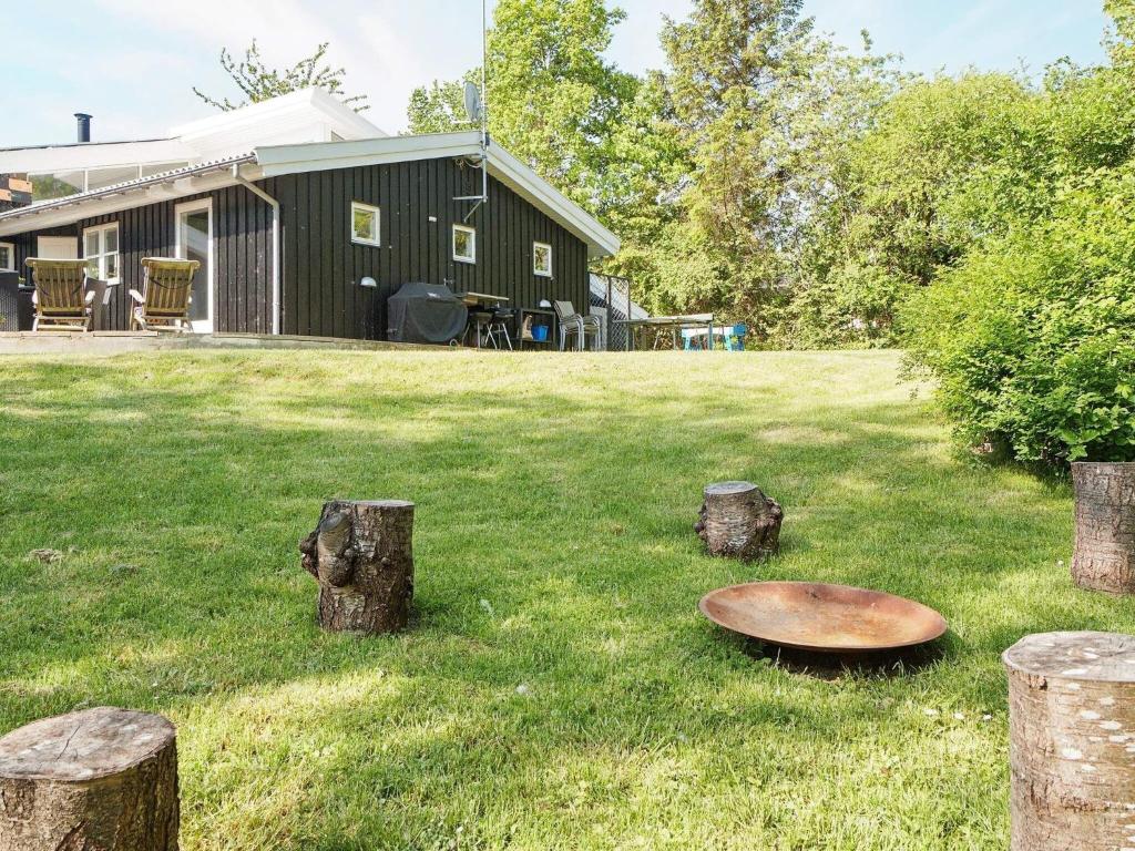 a green yard with a metal object in the grass at 8 person holiday home in Græsted-By Traum in Udsholt Sand
