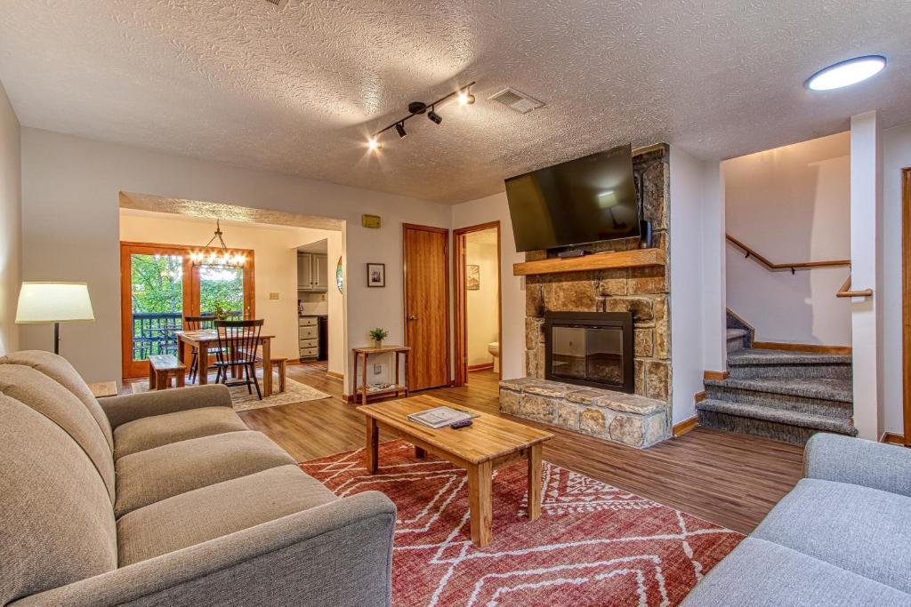 a living room with a couch and a fireplace at Pool-Pinecrest Townhomes-Full Building-14bed17bath in Pigeon Forge