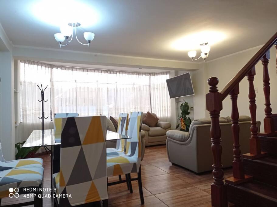 a living room with a table and a couch at casa hospedaje regina marie in Huaraz