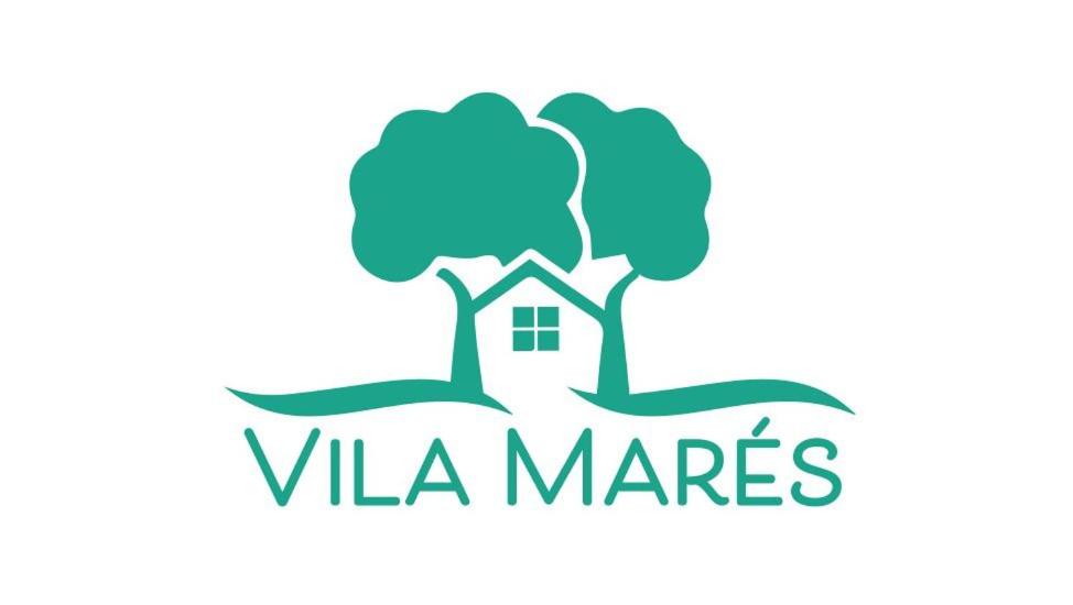 a logo for a real estate company with a house and trees at Vila Marés in São Cristóvão