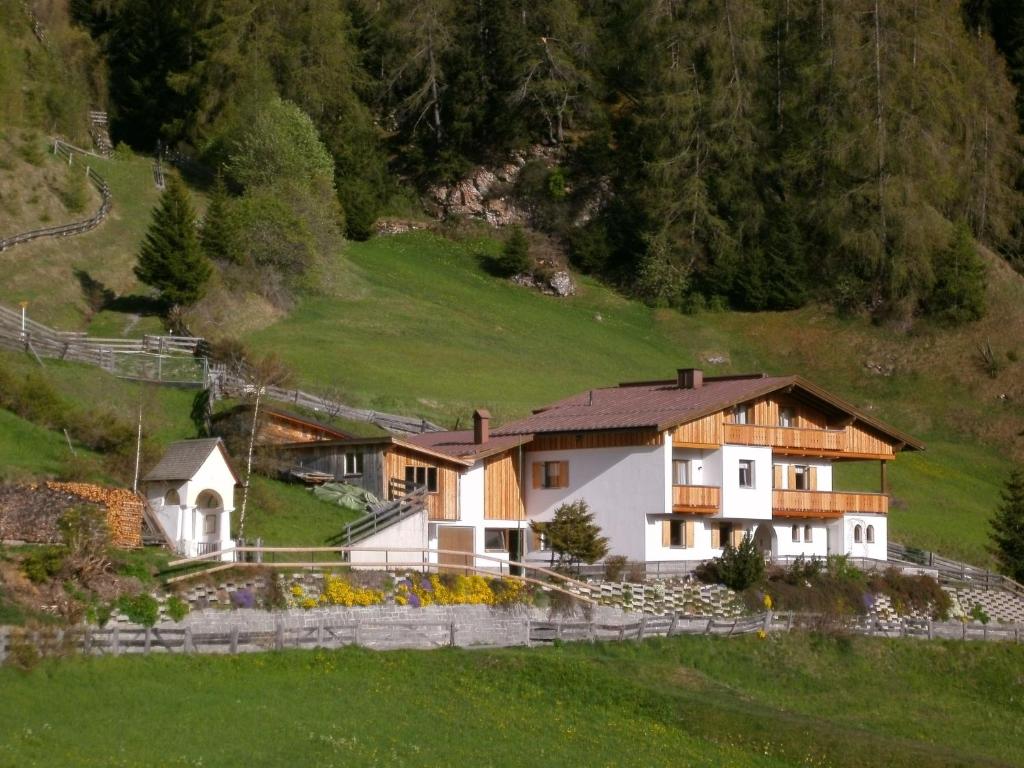 a house in the middle of a green hill at Haus Moritz in Nauders
