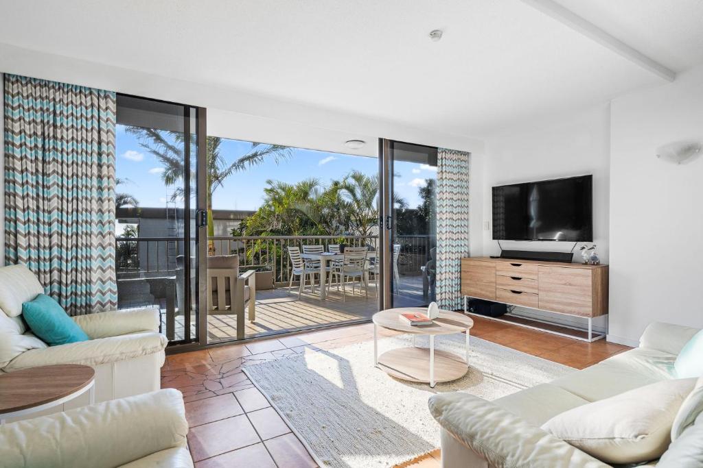 a living room with a couch and a tv at The Rocks Resort Unit 2i in Gold Coast