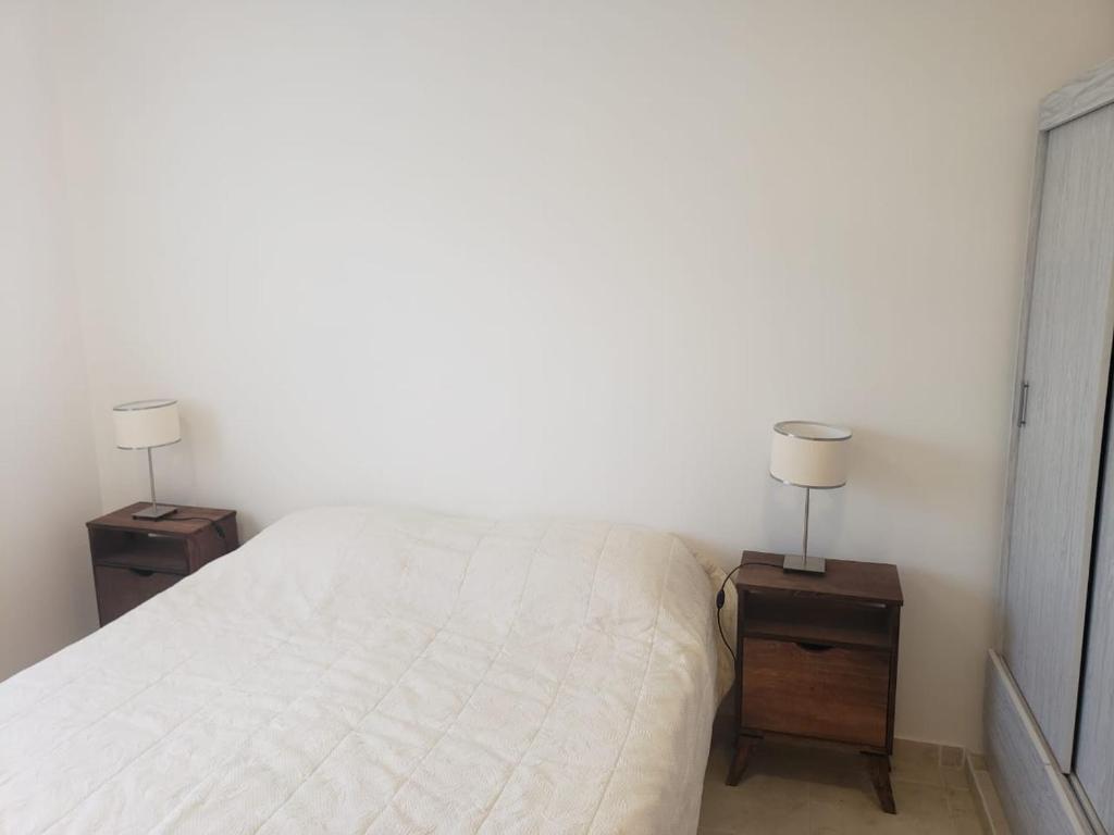 a bedroom with two night stands with a bed and two lamps at Luminoso dpto con wifi in San Luis