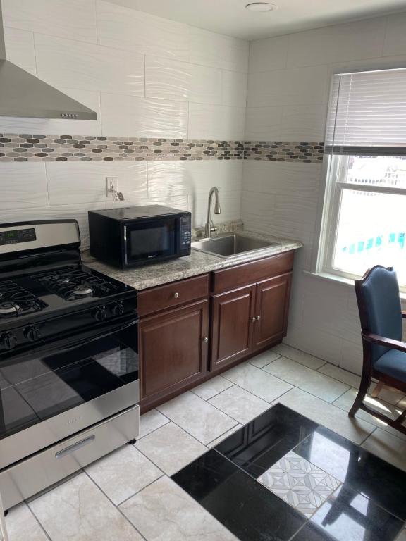 a kitchen with a stove and a sink at Shore Beach Houses - 38 A Lincoln Avenue in Seaside Heights