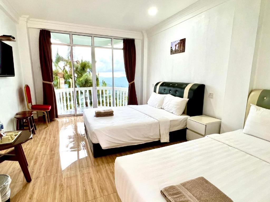 Postel nebo postele na pokoji v ubytování JR RESORT
