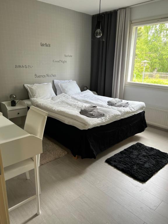 a bedroom with a bed and a window and a chair at Wiitakoto in Viitasaari