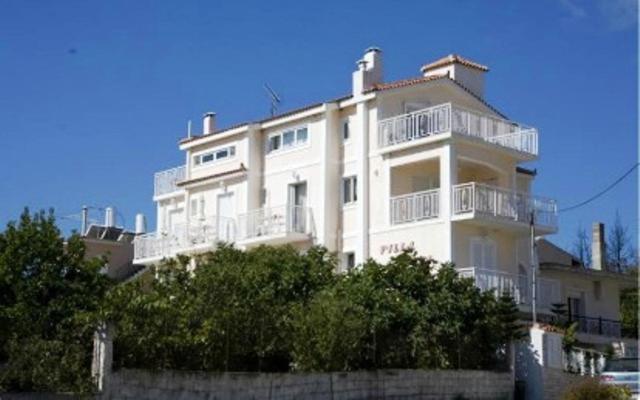 a large white building with balconies on top of it at Villa Sofia in Skala