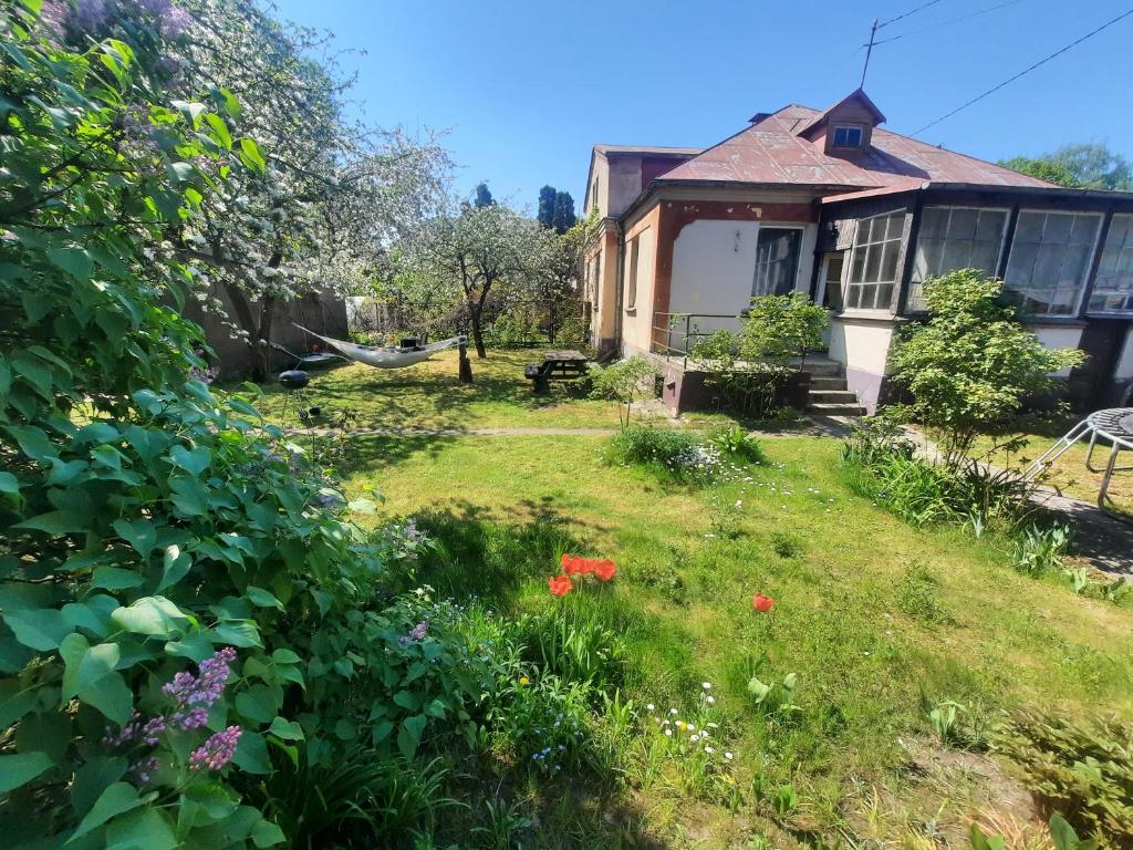 a garden in front of a house at Cozy private house with a yard & parking in Rīga
