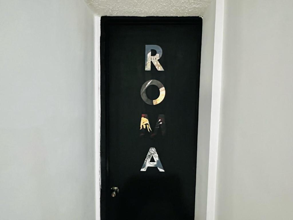 a door with the letters ra painted on it at Habitación Roma in Mexico City