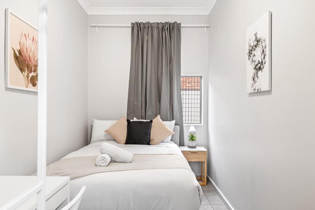 a bedroom with two beds and a window at Signature Double Room in Auburn in Sydney