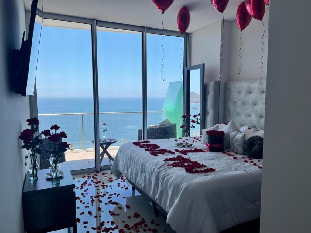 a bedroom with a bed with flowers on the floor at Camino al Mar in Mazatlán
