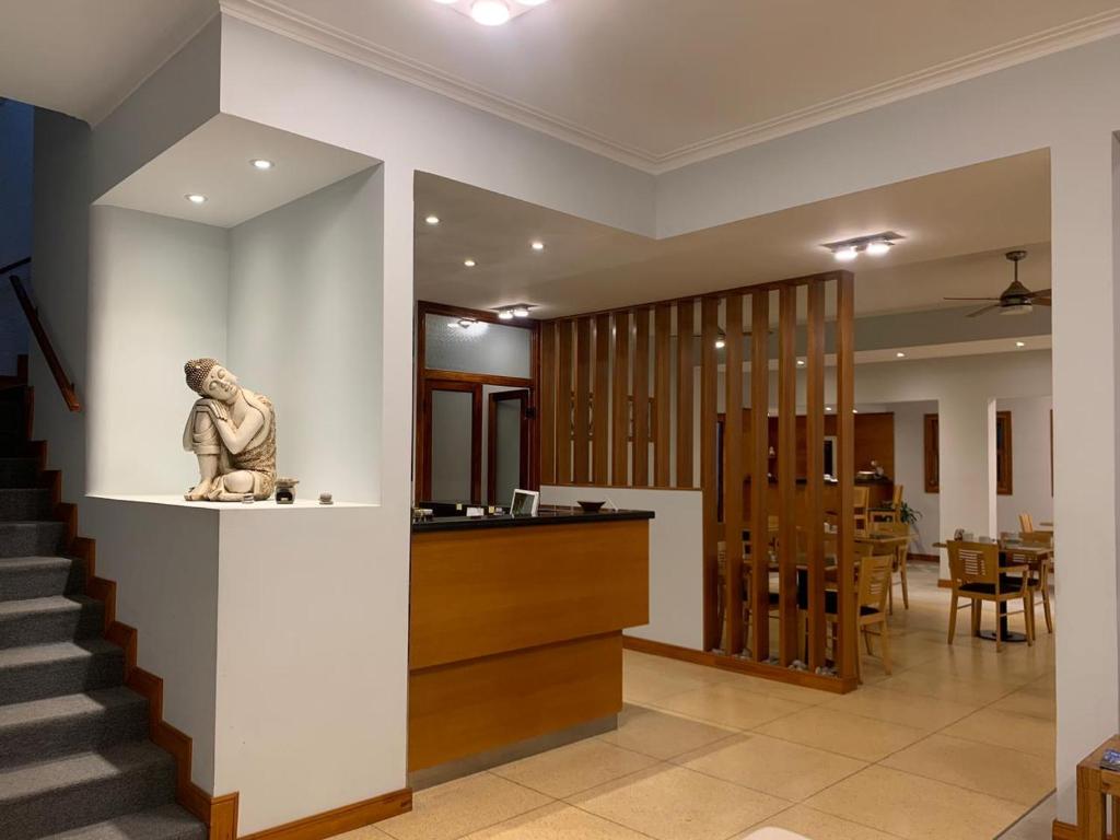 a statue of a monkey sitting on a counter in a room at De La Plaza Hotel in Villa Gesell